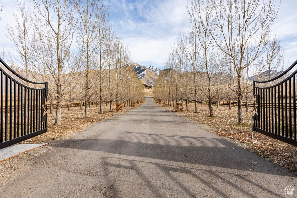 View of asphalt road featuring a mountain view and a view of countryside