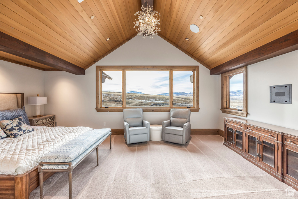 Bedroom featuring a chandelier, light carpet, vaulted ceiling, a mountain view, and wood ceiling