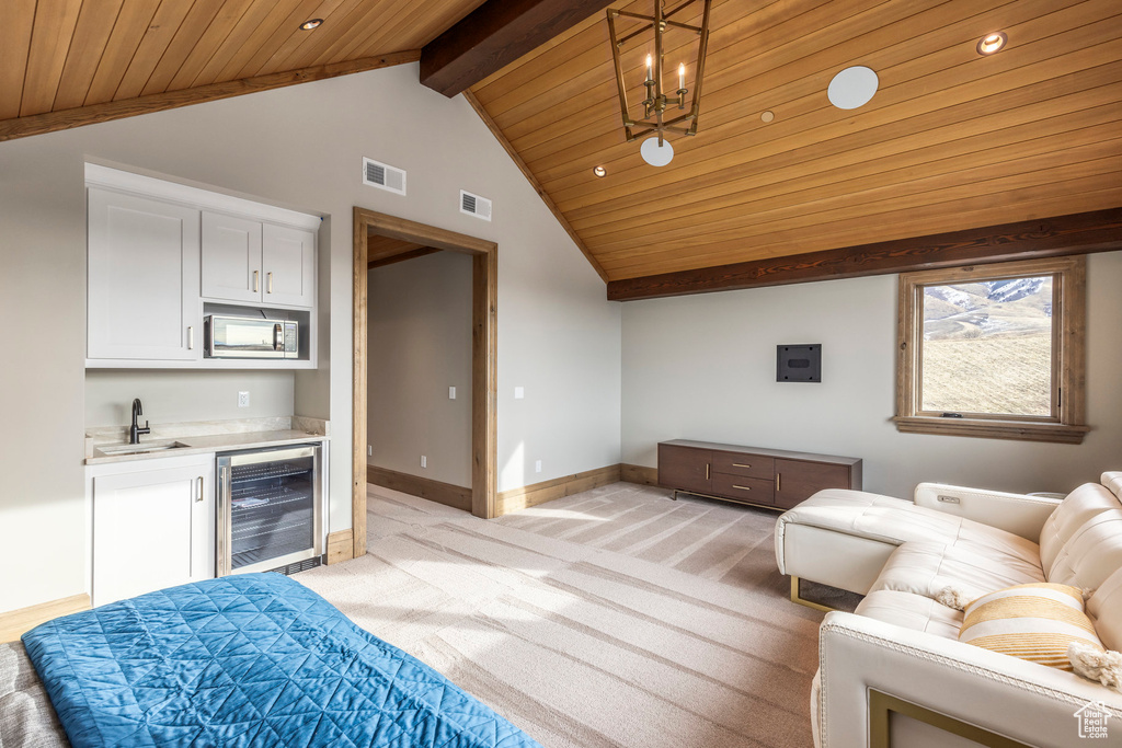 Living room featuring wine cooler, bar with sink, wooden ceiling, light carpet, and recessed lighting