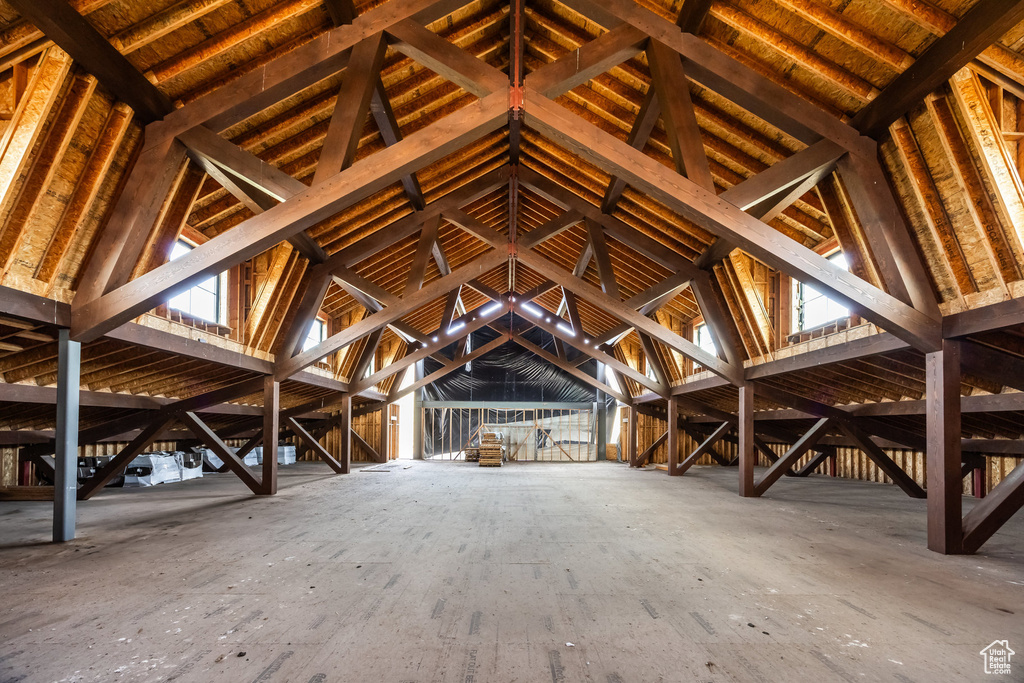 Unfinished attic featuring an upstairs landing
