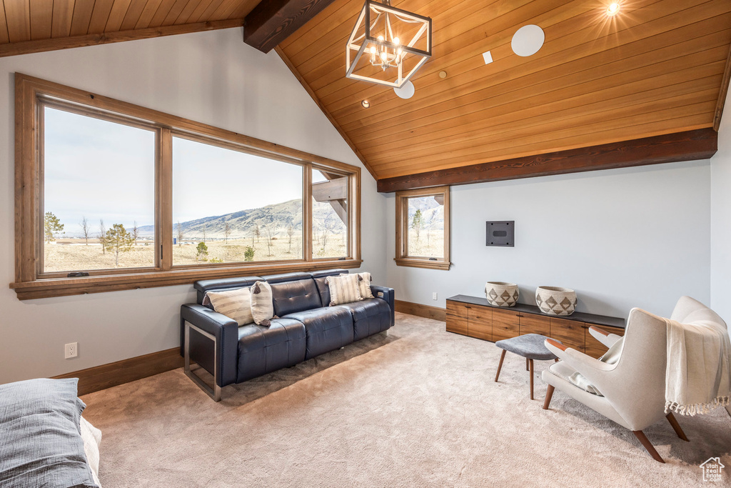 Living area with wood ceiling, a chandelier, a mountain view, and light colored carpet