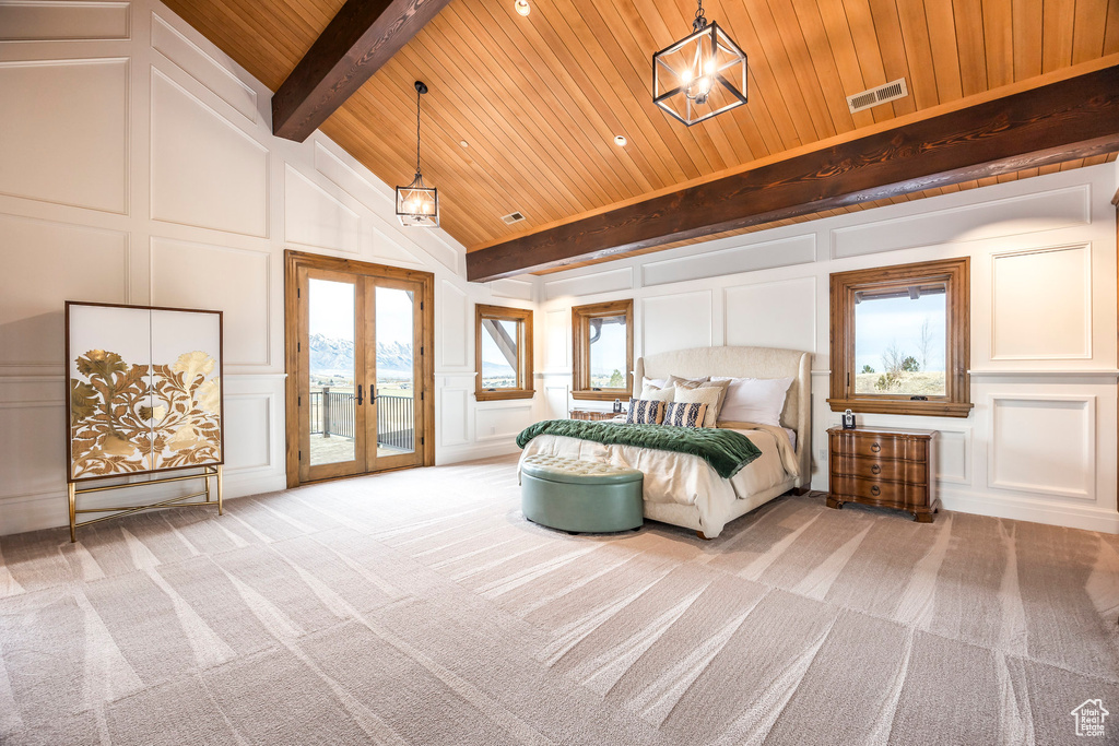 Carpeted bedroom featuring a decorative wall, access to exterior, french doors, a wood ceiling with exposed beams, and high vaulted ceiling