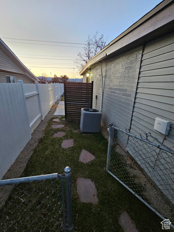 Yard at dusk featuring cooling unit