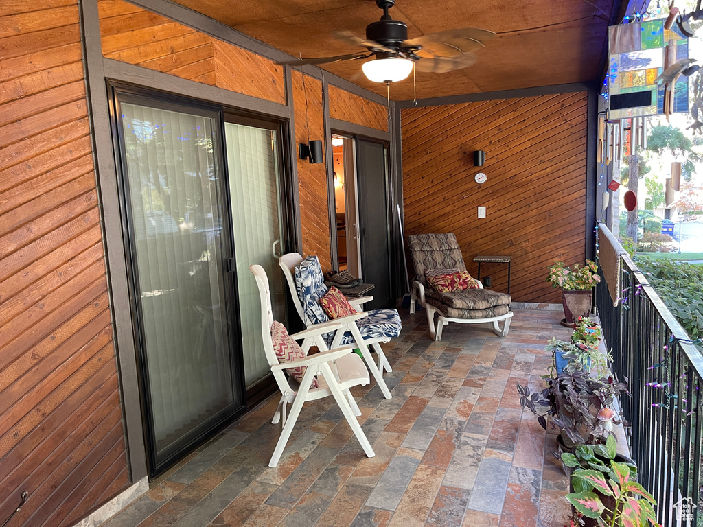 View of patio featuring ceiling fan and a balcony