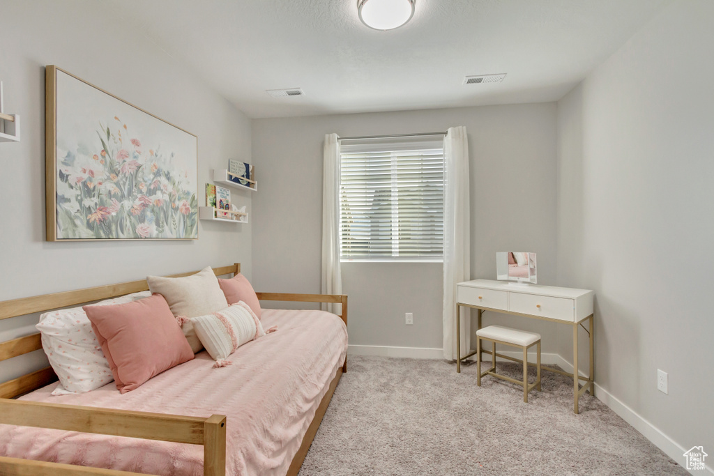 Bedroom featuring light colored carpet