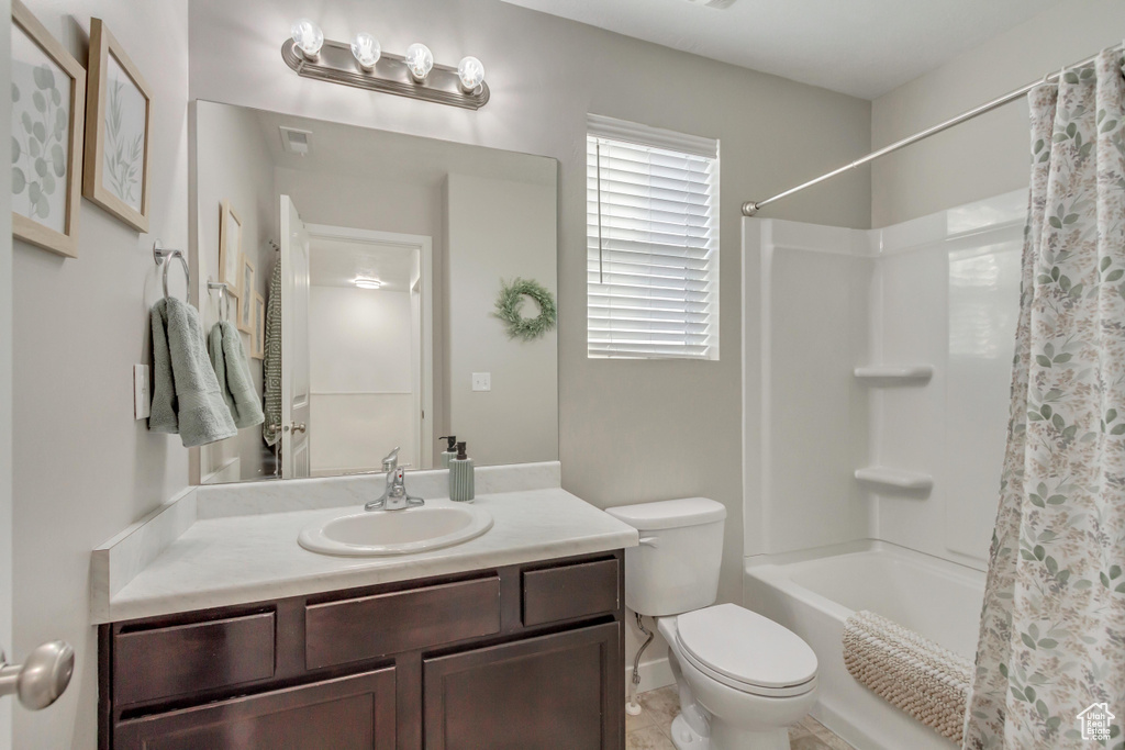 Bathroom with tile patterned floors, vanity, and toilet