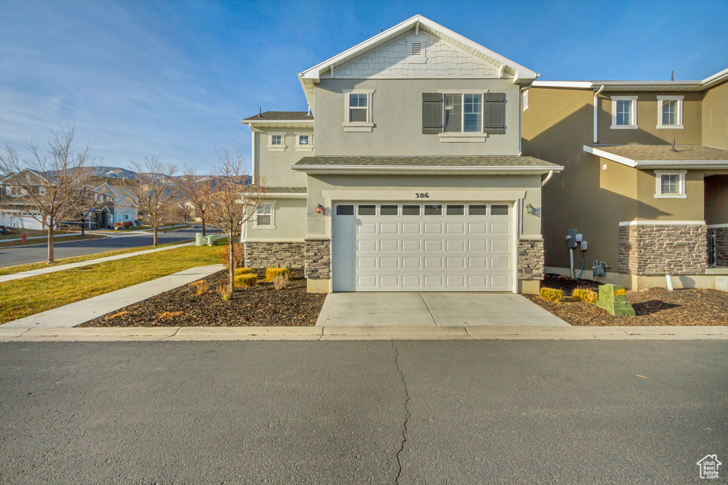 View of front facade featuring a garage