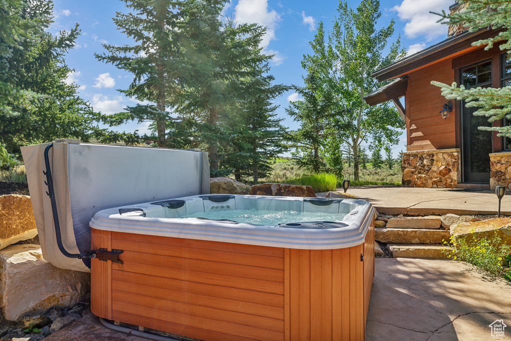 View of patio featuring a hot tub