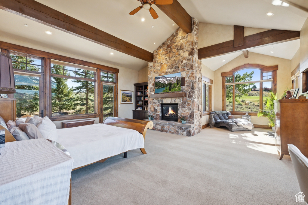 Carpeted bedroom featuring multiple windows, beam ceiling, a fireplace, recessed lighting, and high vaulted ceiling