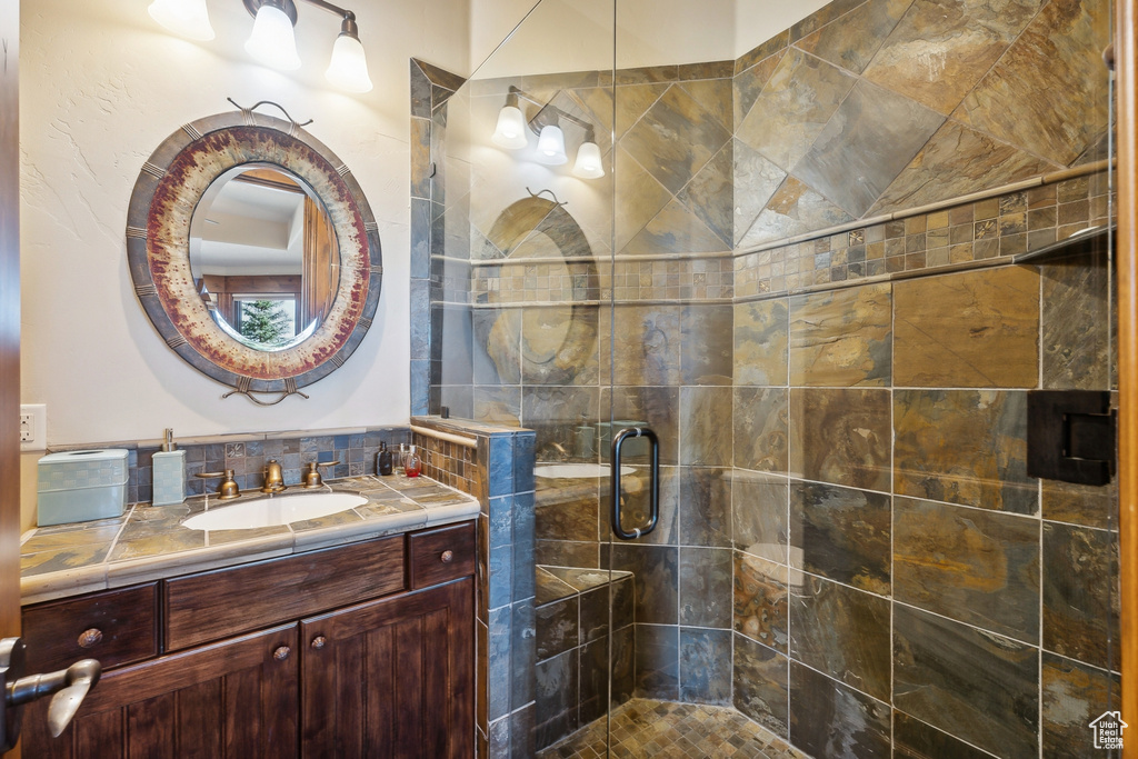 Full bathroom with vanity and a stall shower
