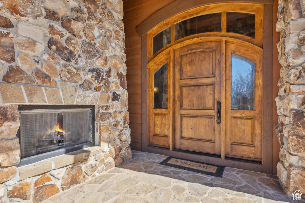 Doorway to property featuring a fireplace