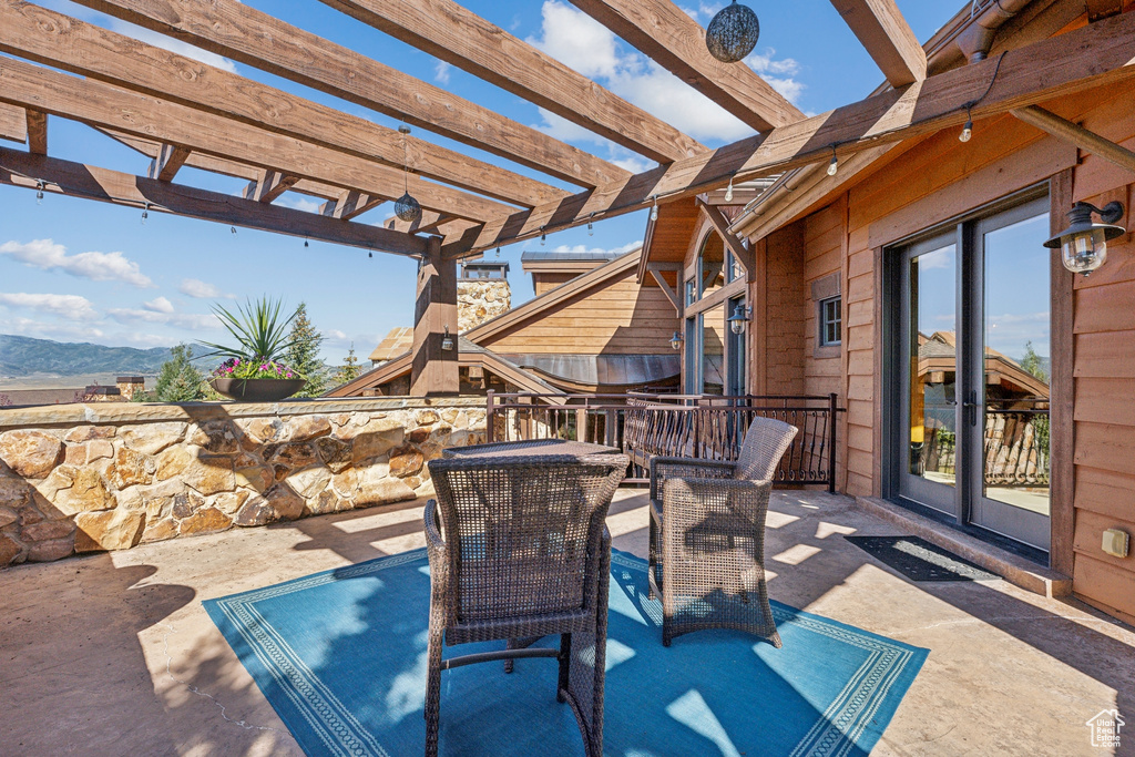 View of patio with a pergola and a mountain view