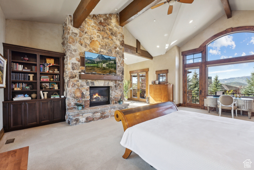 Carpeted bedroom featuring beamed ceiling, a stone fireplace, recessed lighting, high vaulted ceiling, and access to outside