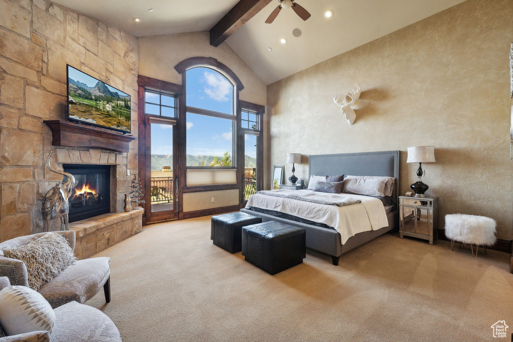 Carpeted bedroom with beam ceiling, high vaulted ceiling, a fireplace, access to outside, and a ceiling fan
