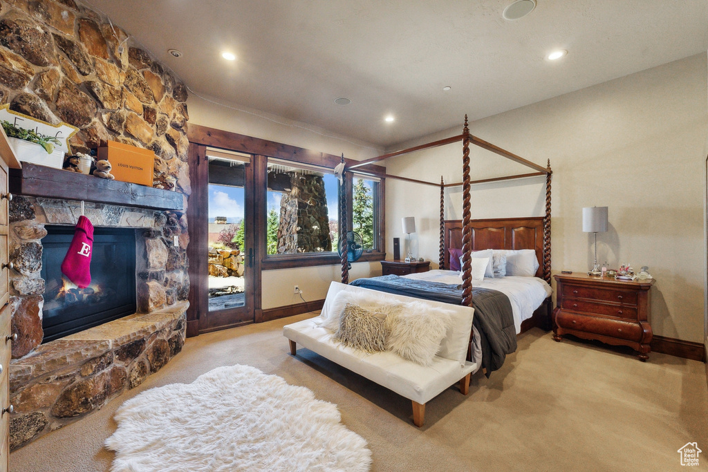 Bedroom featuring carpet floors, access to exterior, recessed lighting, baseboards, and a fireplace