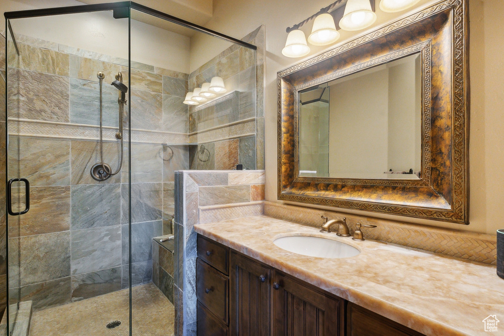Full bathroom featuring a shower stall and vanity