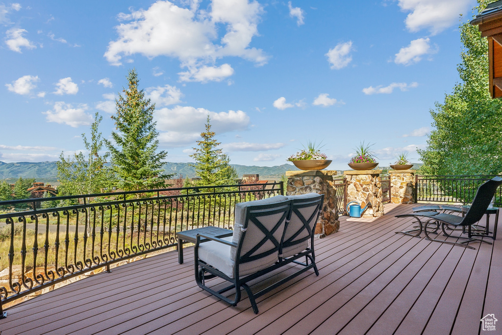 Wooden terrace featuring a mountain view