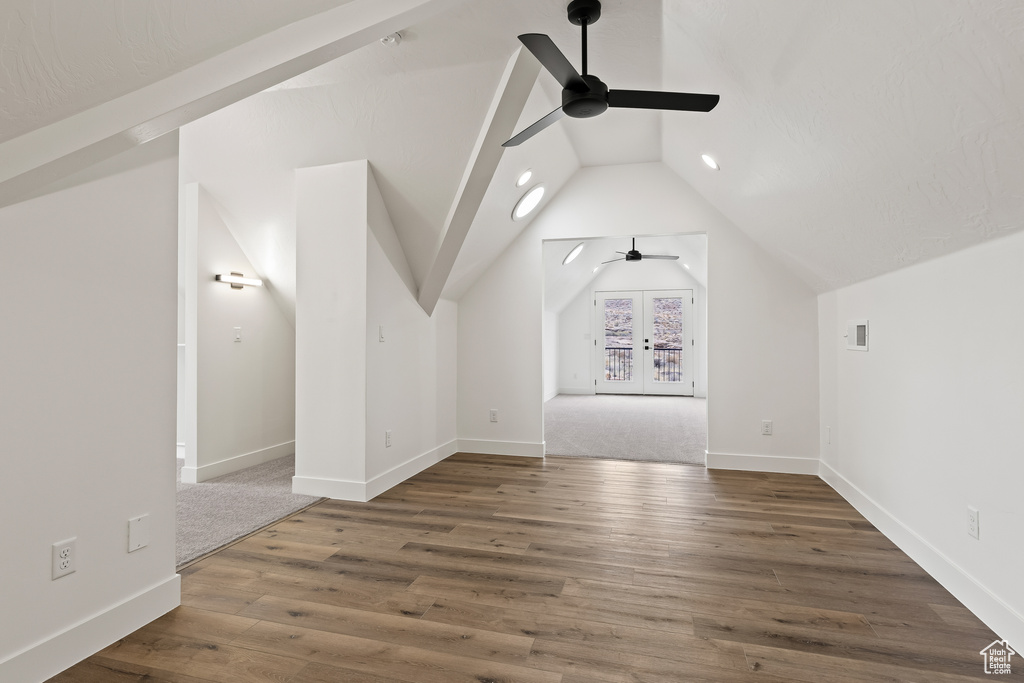 Additional living space with vaulted ceiling, ceiling fan, french doors, and dark hardwood / wood-style floors