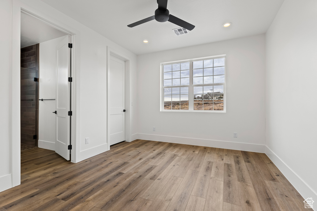 Unfurnished bedroom with light hardwood / wood-style flooring and ceiling fan