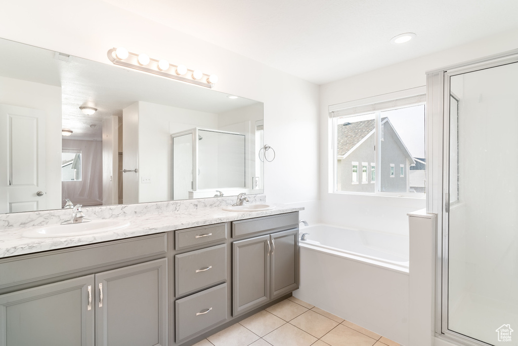 Bathroom with tile patterned flooring, vanity, and independent shower and bath