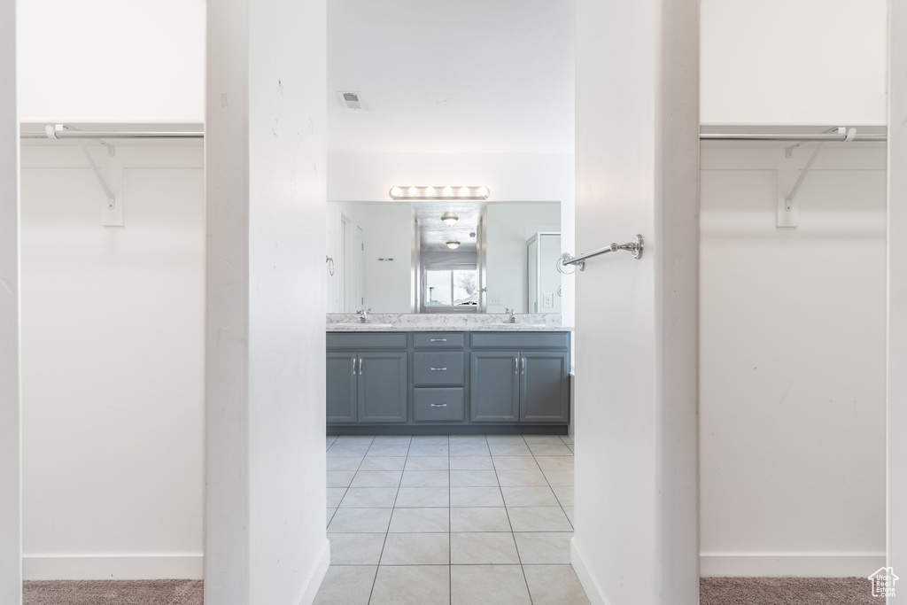 Bathroom featuring tile patterned flooring and vanity