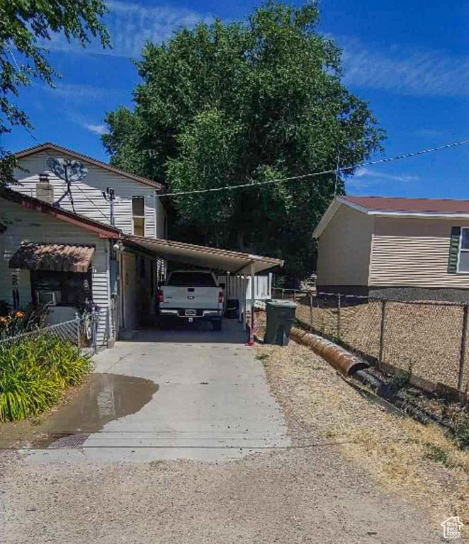 View of side of home with a carport