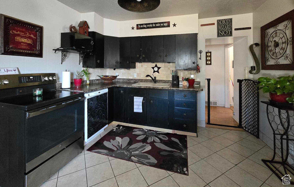 Kitchen with dishwasher, sink, electric stove, decorative backsplash, and light tile patterned flooring