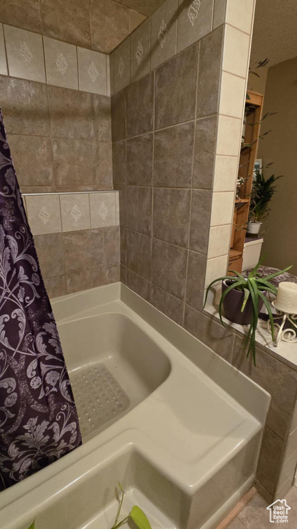 Bathroom featuring curtained shower