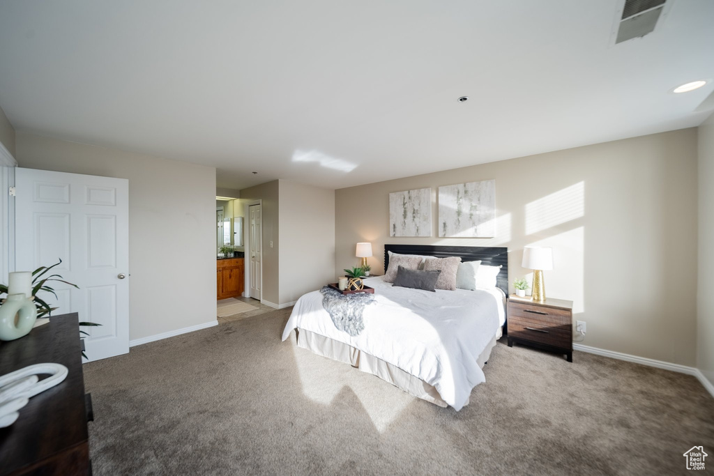 Bedroom featuring carpet and ensuite bathroom