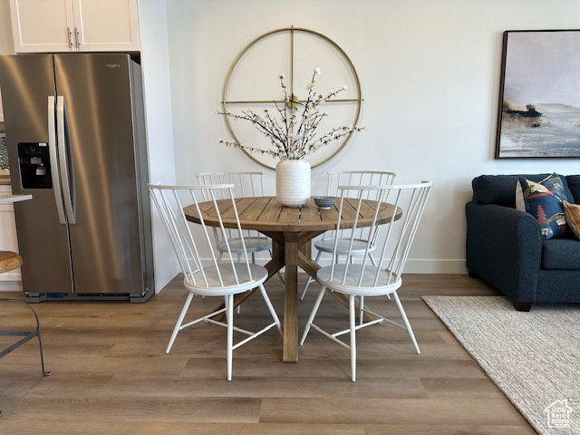 Dining area with light wood finished floors and baseboards