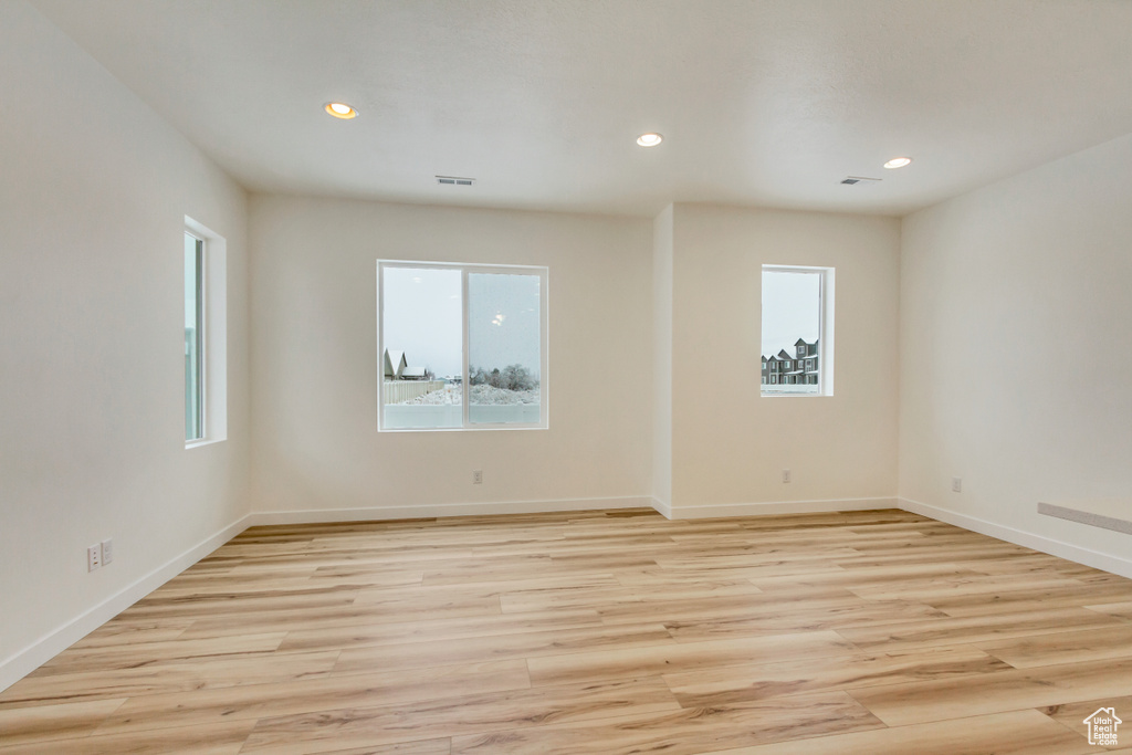 Spare room with recessed lighting, baseboards, visible vents, and light wood-type flooring