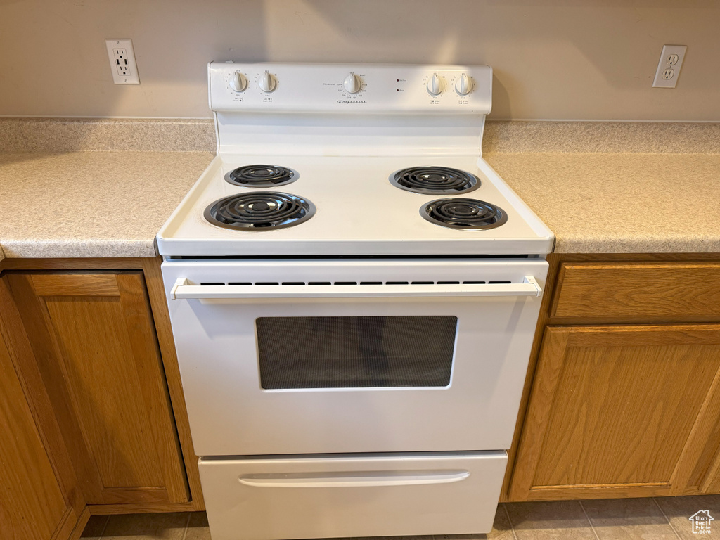 Kitchen with white range with electric cooktop