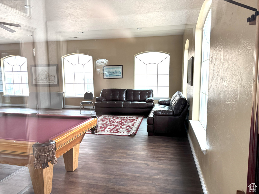 Playroom with ceiling fan, dark hardwood / wood-style flooring, a textured ceiling, and pool table