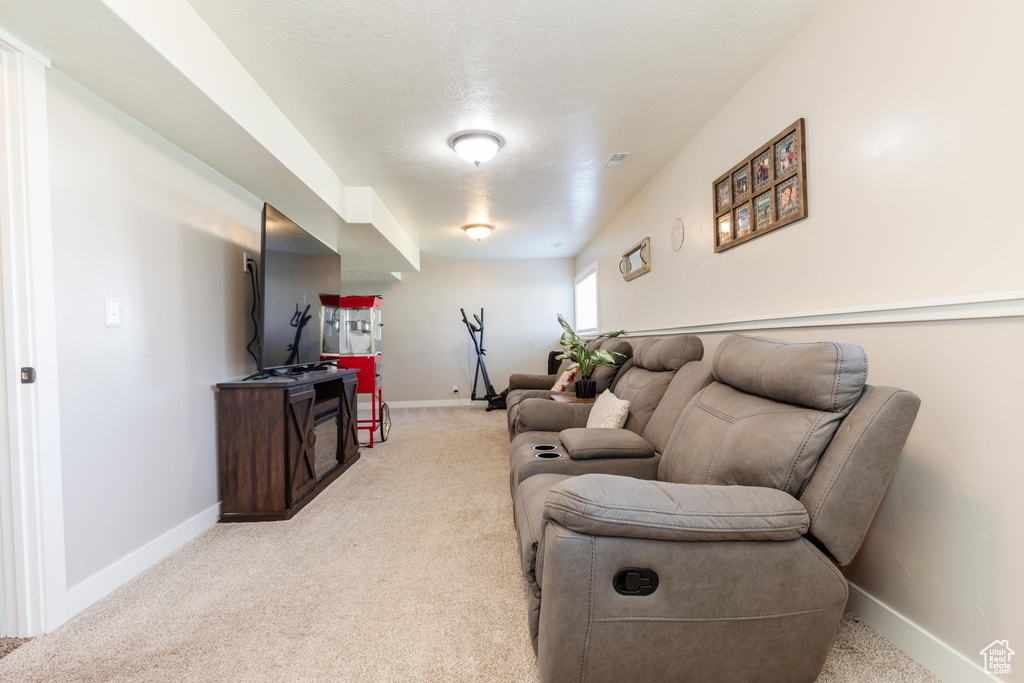 Living area with light colored carpet and baseboards