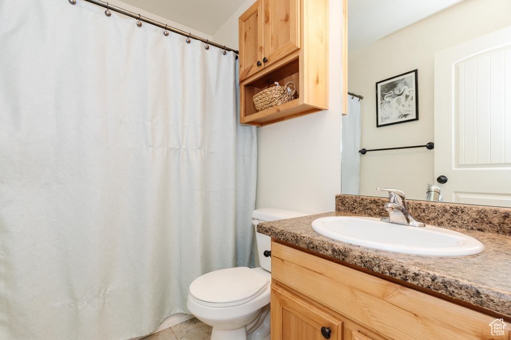 Full bath featuring vanity and toilet