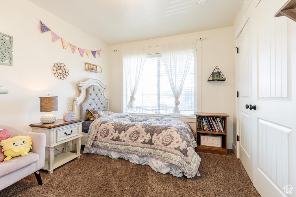 Carpeted bedroom with a closet