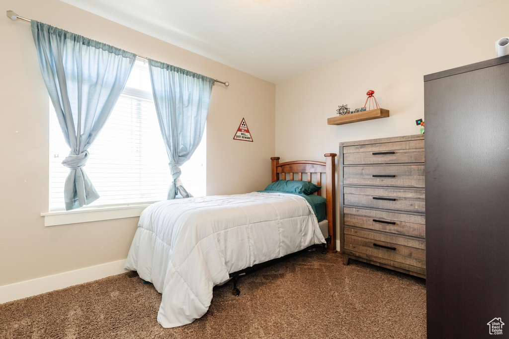 Carpeted bedroom with multiple windows