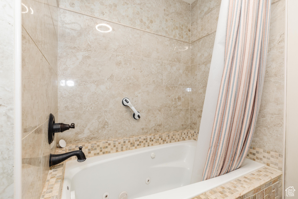Bathroom featuring a combined bath / shower with jetted tub