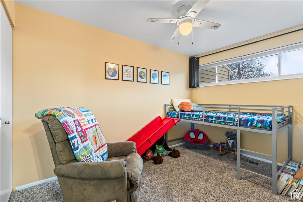 Bedroom with ceiling fan and carpet floors