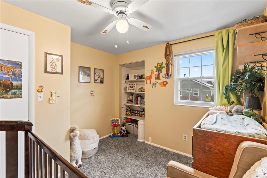 Bedroom featuring ceiling fan and carpet floors