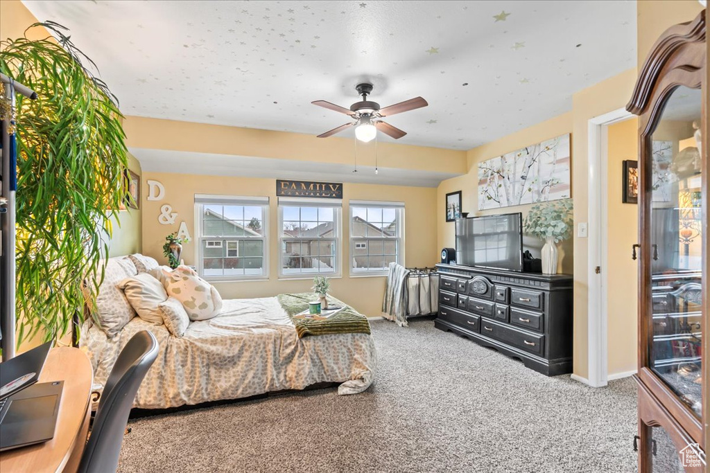 Bedroom with ceiling fan and carpet