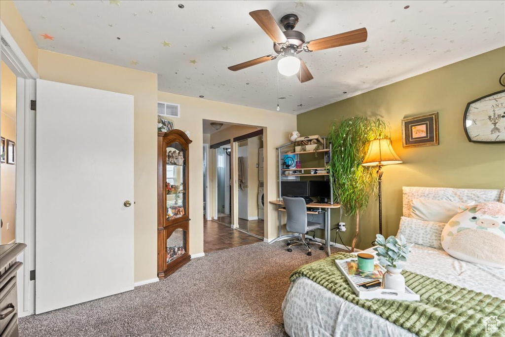 Bedroom featuring ceiling fan and dark carpet