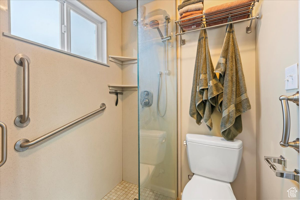 Bathroom featuring toilet and walk in shower