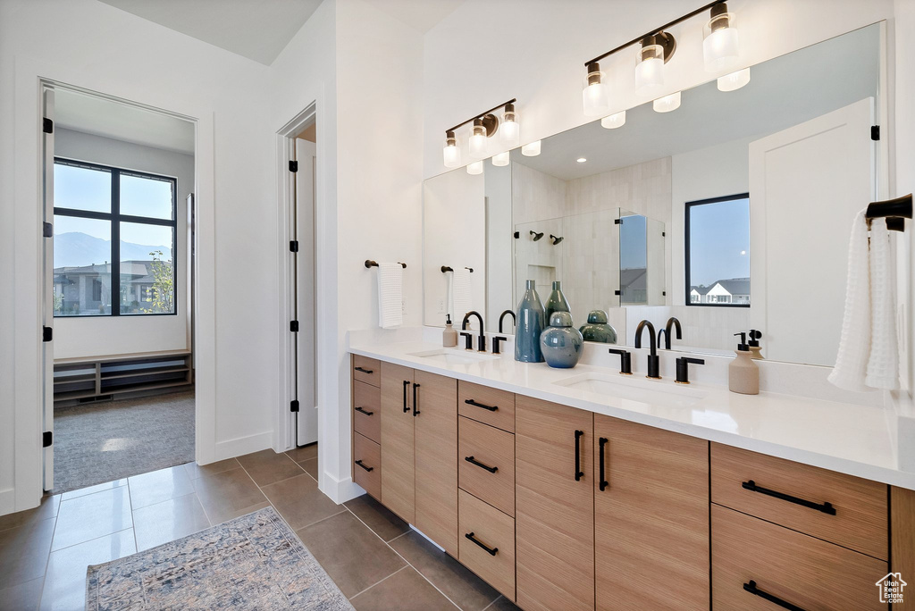 Bathroom featuring a mountain view, tile patterned flooring, vanity, and a shower with door