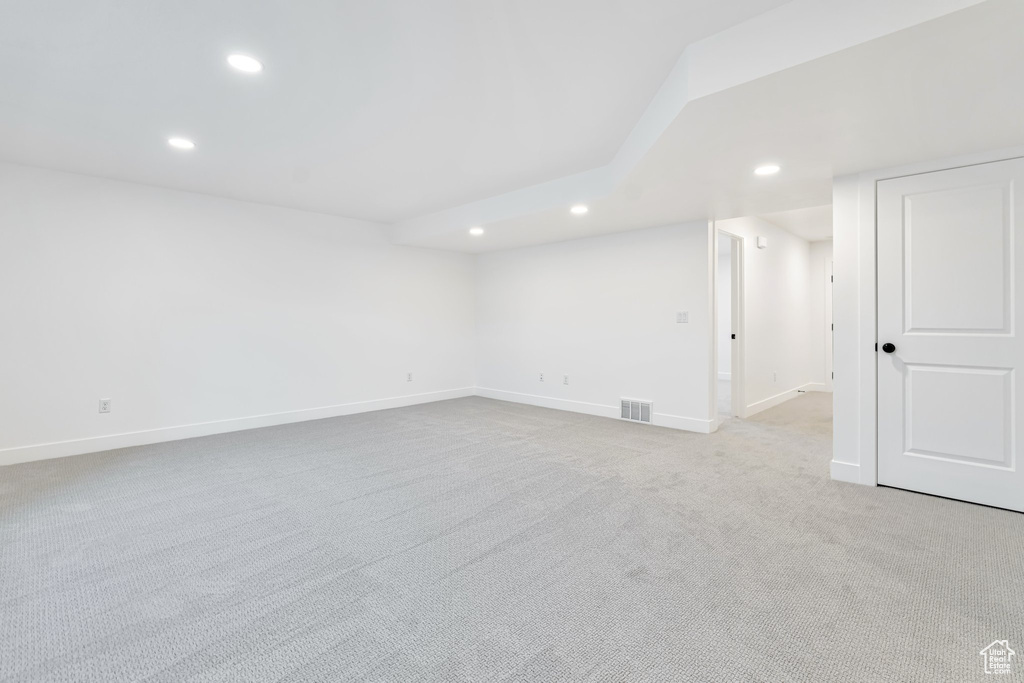 Empty room featuring light carpet