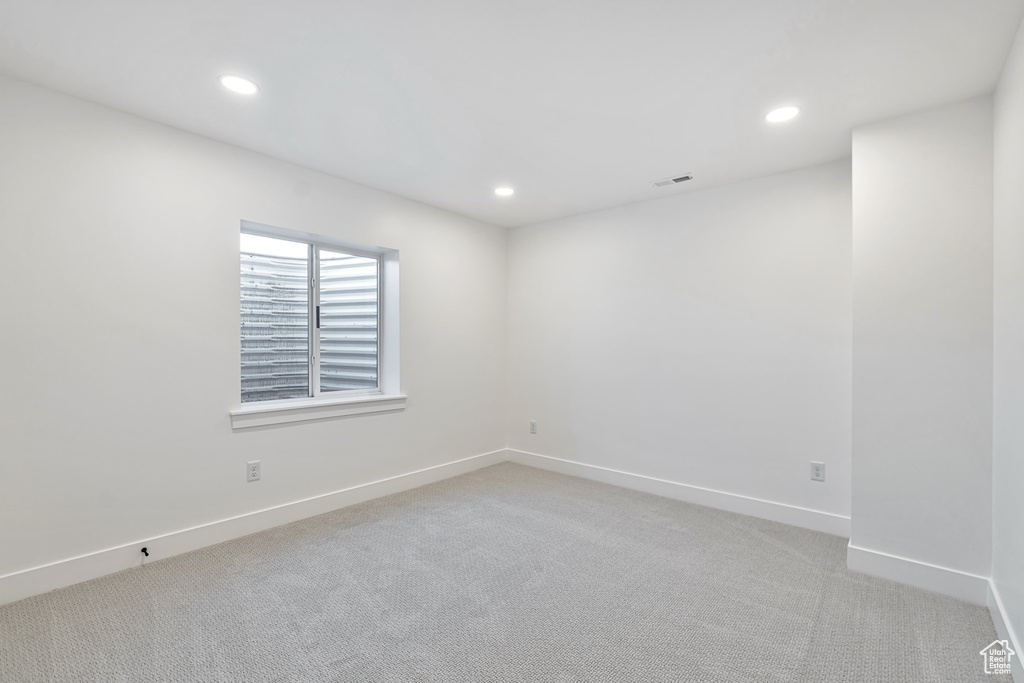 Empty room featuring light colored carpet