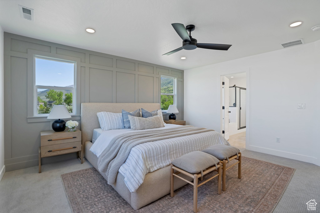 Carpeted bedroom with ceiling fan