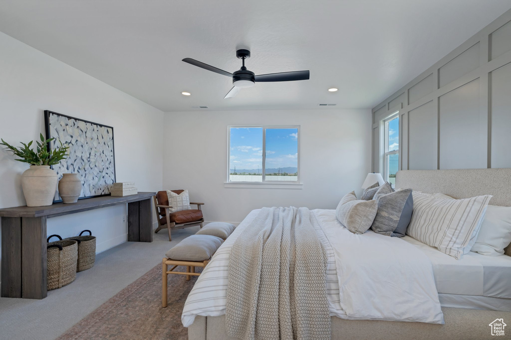 Bedroom featuring ceiling fan and light carpet