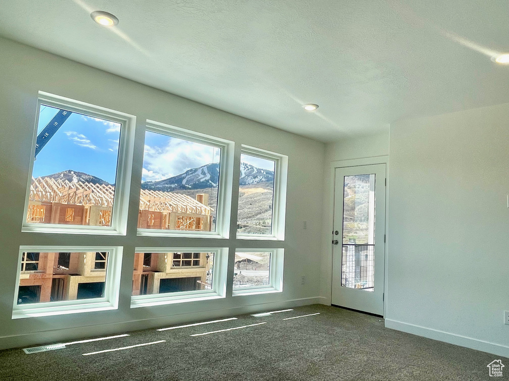 Interior space with baseboards and carpet