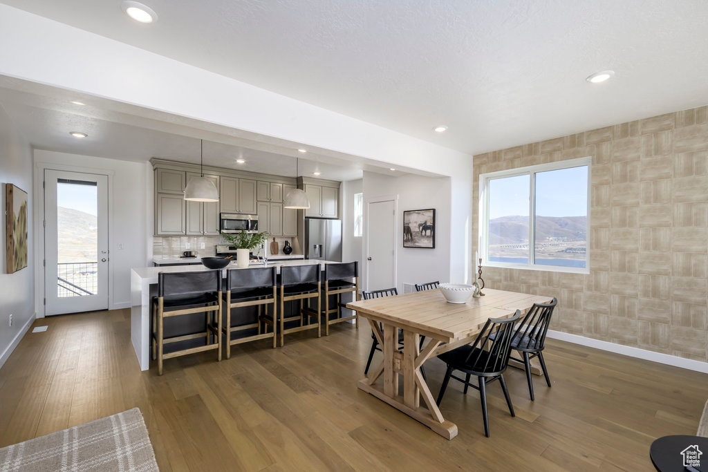 Dining space with baseboards, recessed lighting, and wood finished floors